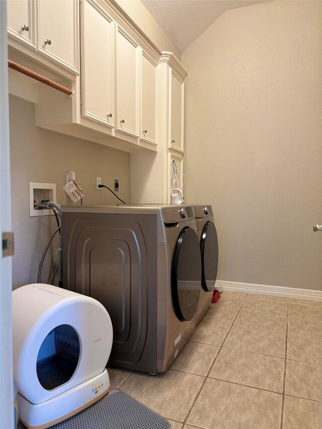 2331 Scottsdale Ct, League City, TX 77573 - laundry area featuring cabinet space, independent washer and dryer, light tile patterned floors, and baseboards
