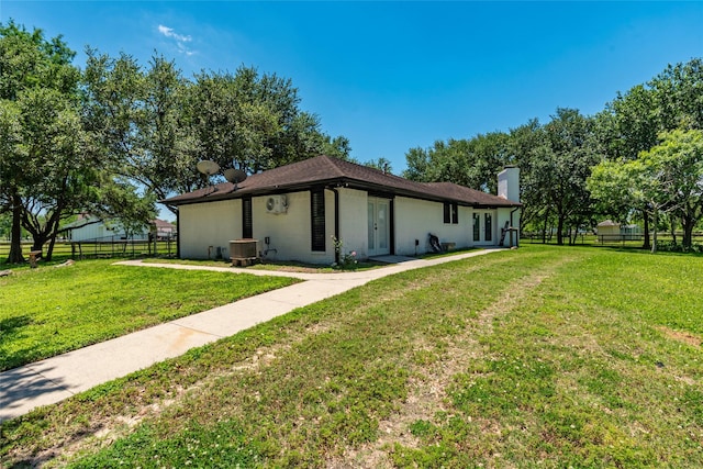 15329 Cedar St, Santa Fe, TX 77517 - back of property with central air condition unit, a chimney, and french doors