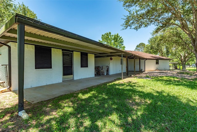 15329 Cedar St, Santa Fe, TX 77517 - back of property featuring a lawn, brick siding, and a patio