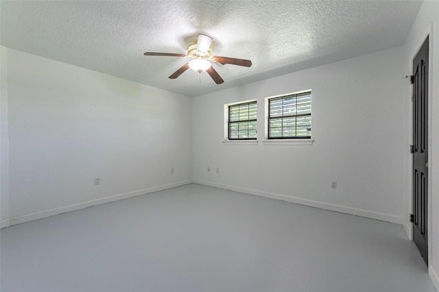 15329 Cedar St, Santa Fe, TX 77517 - spare room with ceiling fan, a textured ceiling, concrete flooring, and baseboards