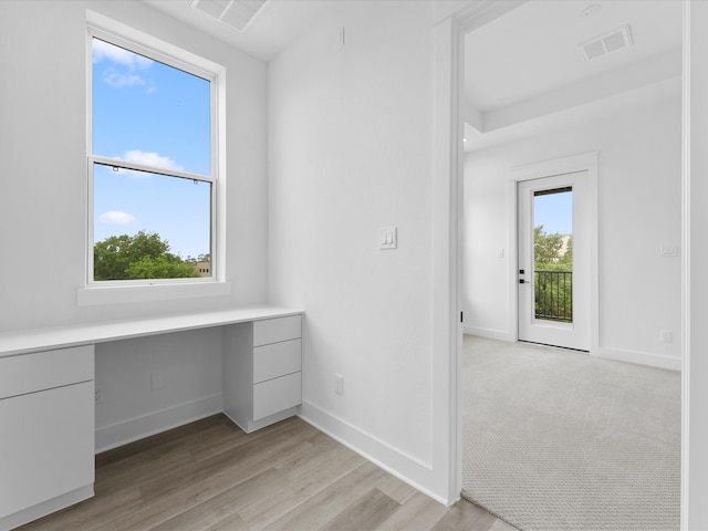5203 San Juan St, Houston, TX 77020 - unfurnished office featuring built in desk, light wood-style floors, and baseboards