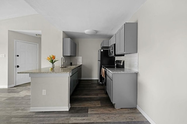 10101 S Gessner Rd Unit 811, Houston, TX 77071 - kitchen featuring a sink, gray cabinetry, appliances with stainless steel finishes, and a peninsula
