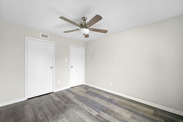 10101 S Gessner Rd Unit 811, Houston, TX 77071 - unfurnished bedroom featuring dark wood finished floors, baseboards, and a ceiling fan