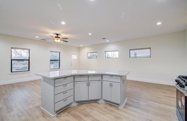 1853 Lombardy St, Houston, TX 77023 - kitchen with stainless steel range with gas cooktop, a center island, open floor plan, plenty of natural light, and recessed lighting