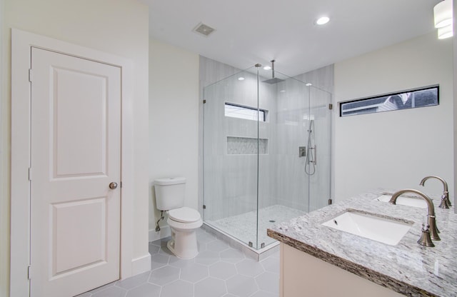 1853 Lombardy St, Houston, TX 77023 - bathroom featuring a shower stall, toilet, recessed lighting, tile patterned floors, and vanity