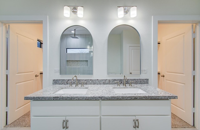 1853 Lombardy St, Houston, TX 77023 - bathroom featuring speckle patterned floor, double vanity, and a shower