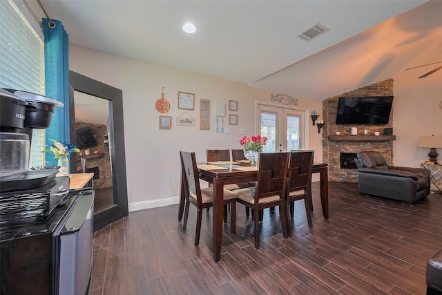 3207 Pheasant Trail Dr, Sugar Land, TX 77498 - dining space with a stone fireplace, dark wood finished floors, lofted ceiling, baseboards, and french doors