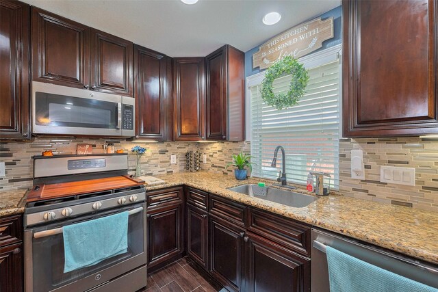 3207 Pheasant Trail Dr, Sugar Land, TX 77498 - kitchen with appliances with stainless steel finishes, a sink, tasteful backsplash, and light stone counters