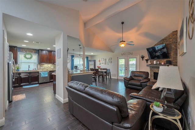 3207 Pheasant Trail Dr, Sugar Land, TX 77498 - living room with ceiling fan, dark wood-style flooring, a stone fireplace, plenty of natural light, and recessed lighting