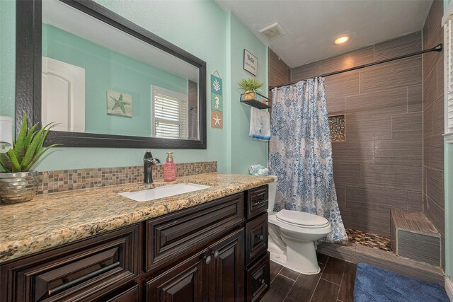 3207 Pheasant Trail Dr, Sugar Land, TX 77498 - bathroom featuring toilet, tiled shower, vanity, wood tiled floors, and recessed lighting