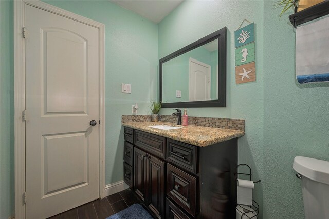 3207 Pheasant Trail Dr, Sugar Land, TX 77498 - half bathroom with toilet, vanity, wood finished floors, and baseboards