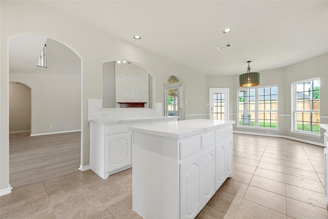 2108 Asbury Ct, Pearland, TX 77581 - kitchen with a center island, white cabinets, light countertops, recessed lighting, and baseboards