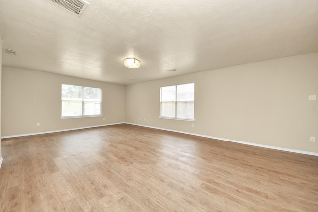 5043 Canyon Blanco Dr, Houston, TX 77045 - unfurnished room with healthy amount of natural light, light wood-type flooring, and baseboards