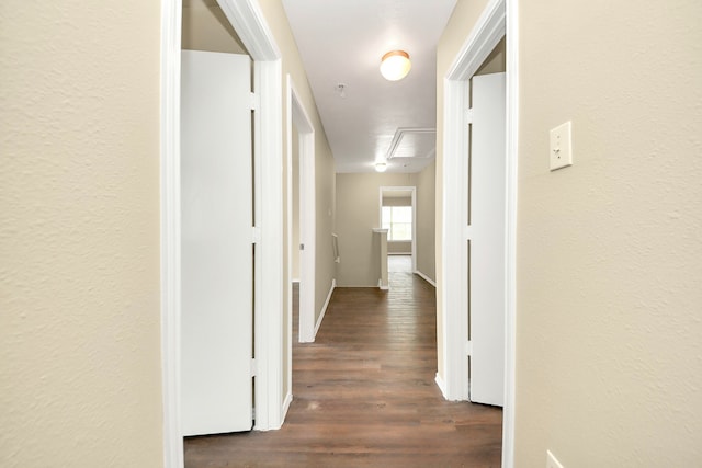 5043 Canyon Blanco Dr, Houston, TX 77045 - hallway featuring dark wood-style flooring, attic access, and baseboards