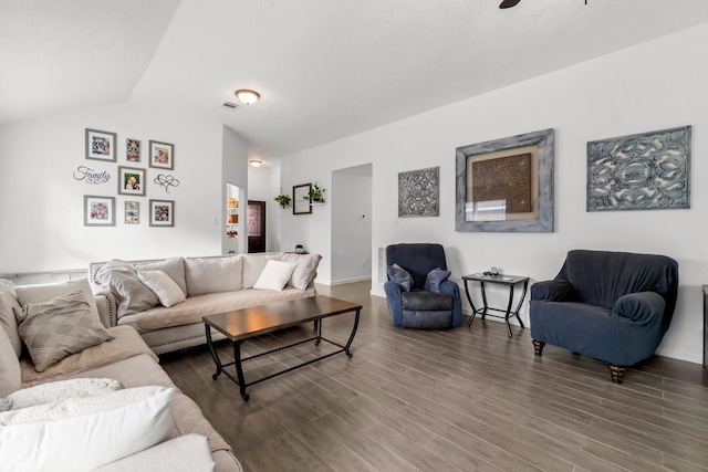 living area with lofted ceiling, wood finished floors, and baseboards