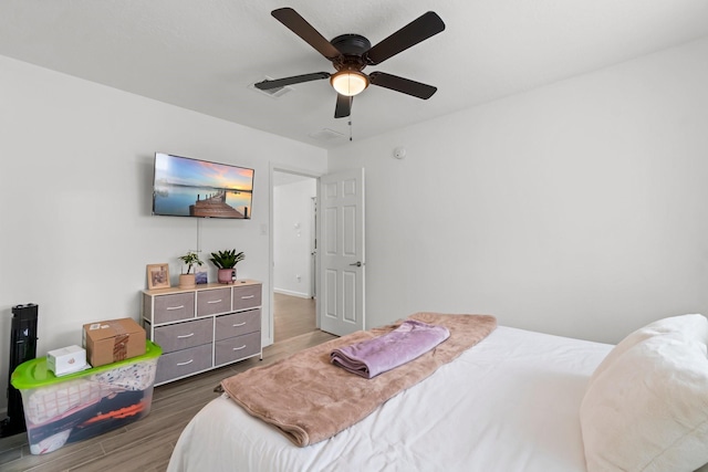 bedroom with wood finished floors and a ceiling fan