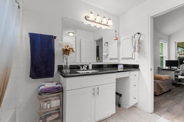 full bathroom featuring vanity, connected bathroom, and tile patterned flooring