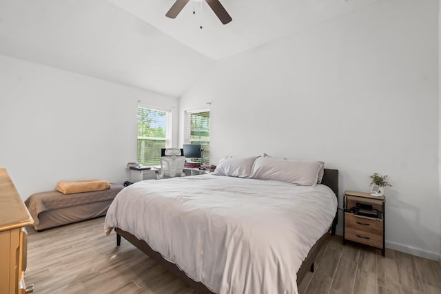 bedroom featuring wood finished floors, vaulted ceiling, and a ceiling fan