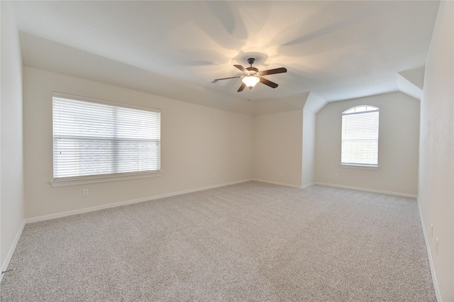 28015 Heritage Stream Dr, Katy, TX 77494 - empty room featuring light carpet, a ceiling fan, baseboards, and vaulted ceiling