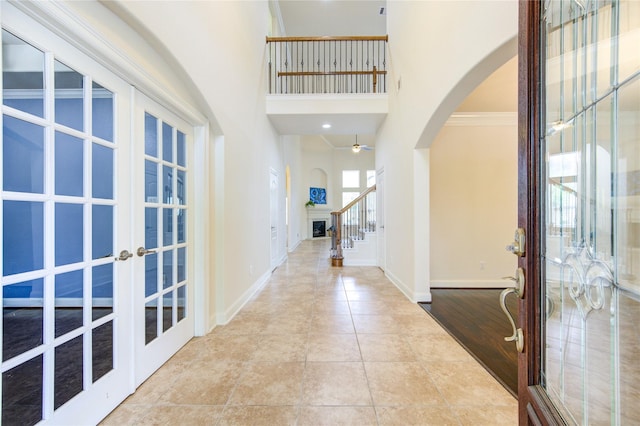 28015 Heritage Stream Dr, Katy, TX 77494 - entrance foyer with arched walkways, french doors, baseboards, a high ceiling, and stairway