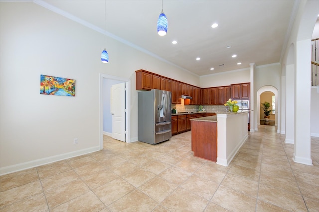 28015 Heritage Stream Dr, Katy, TX 77494 - kitchen featuring stainless steel appliances, arched walkways, decorative backsplash, crown molding, and recessed lighting