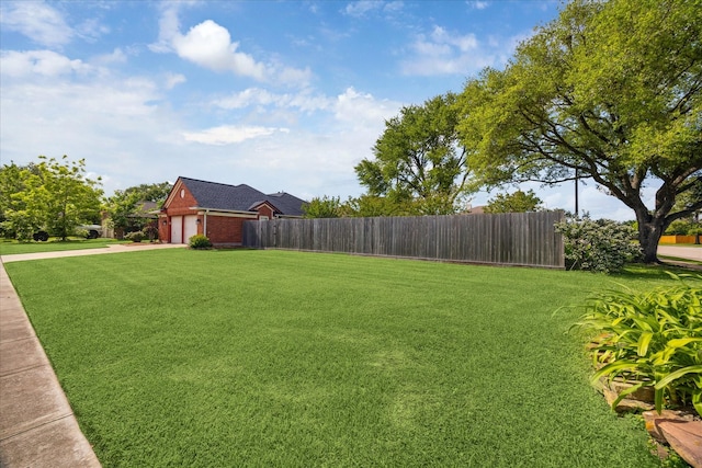 10937 Graywood Ct, La Porte, TX 77571 - view of yard with a garage and concrete driveway