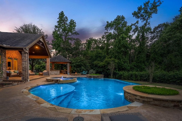 pool at dusk featuring a gazebo, outdoor lounge area, a patio area, and a pool with connected hot tub