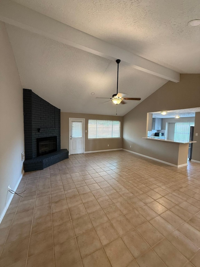 2614 Sicklepod Dr, Houston, TX 77084 - unfurnished living room with a textured ceiling, ceiling fan, light tile patterned floors, a fireplace, and baseboards
