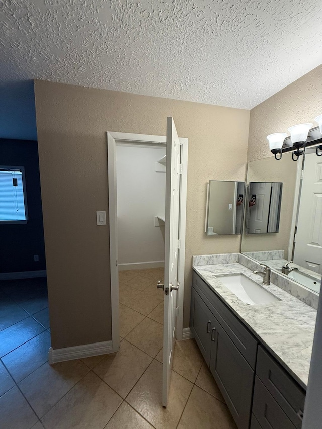 2614 Sicklepod Dr, Houston, TX 77084 - bathroom with a textured ceiling, tile patterned floors, vanity, a textured wall, and a chandelier