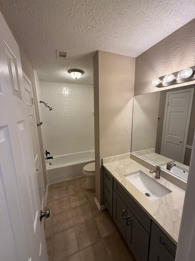 2614 Sicklepod Dr, Houston, TX 77084 - bathroom with vanity, toilet, shower / bathtub combination, tile patterned floors, and a textured ceiling