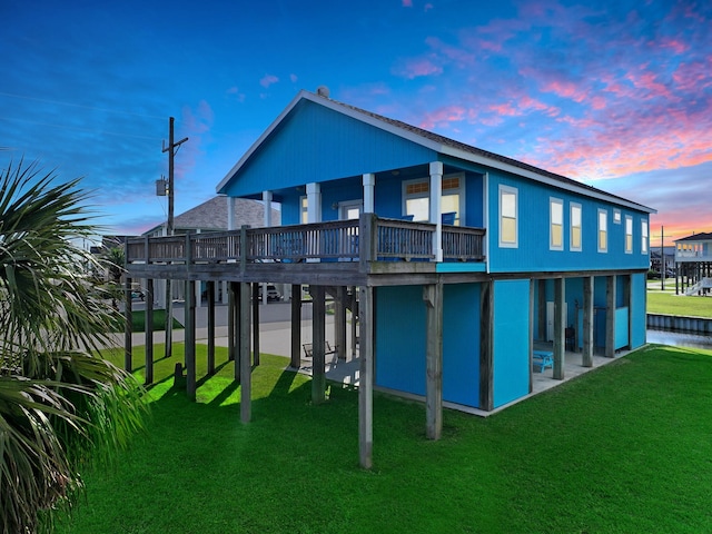 936 Surf Rd, Crystal Beach, TX 77650 - rear view of property with a lawn, a patio, and a wooden deck