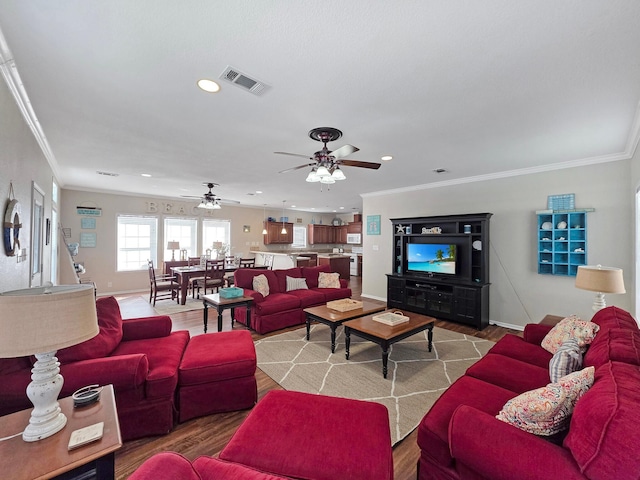 936 Surf Rd, Crystal Beach, TX 77650 - living area with ceiling fan, ornamental molding, recessed lighting, baseboards, and wood finished floors