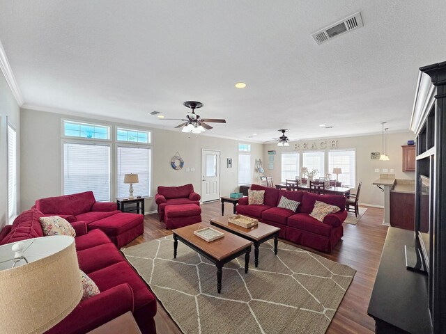 936 Surf Rd, Crystal Beach, TX 77650 - living area featuring crown molding, dark wood-style flooring, baseboards, recessed lighting, and ceiling fan