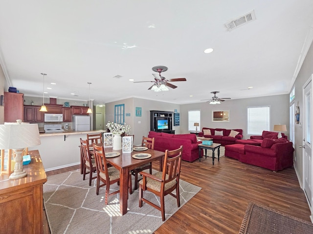 936 Surf Rd, Crystal Beach, TX 77650 - dining space featuring dark wood finished floors, recessed lighting, ornamental molding, and ceiling fan