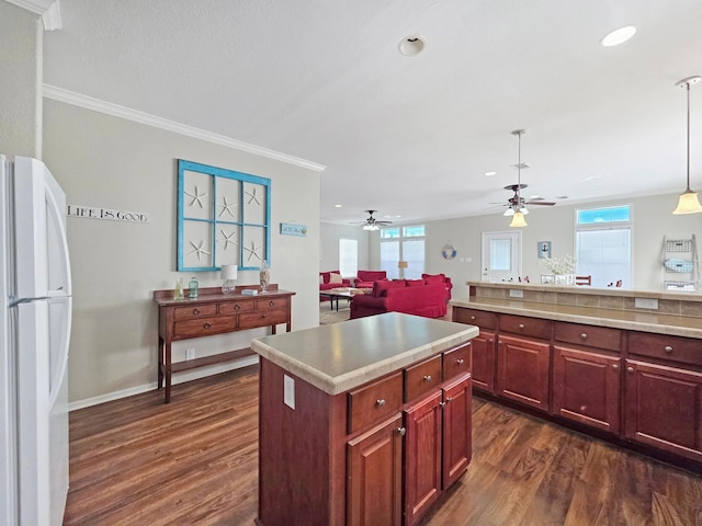 936 Surf Rd, Crystal Beach, TX 77650 - kitchen with freestanding refrigerator, dark wood finished floors, dark brown cabinets, a ceiling fan, and recessed lighting