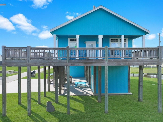 936 Surf Rd, Crystal Beach, TX 77650 - back of house with a lawn and a deck