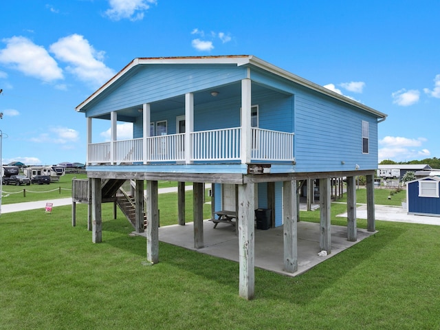 936 Surf Rd, Crystal Beach, TX 77650 - rear view of house with a carport, a lawn, and stairway