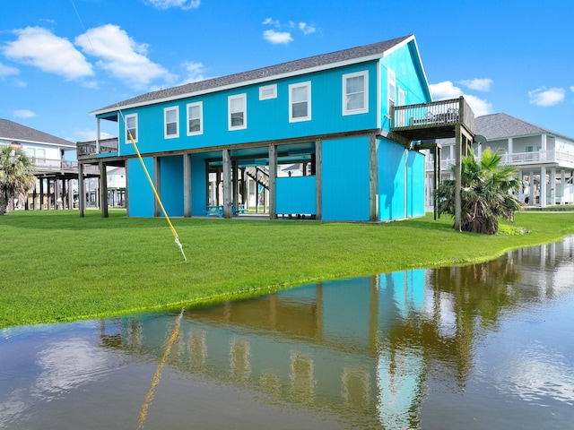 936 Surf Rd, Crystal Beach, TX 77650 - rear view of house with a yard, a water view, a carport, and roof with shingles