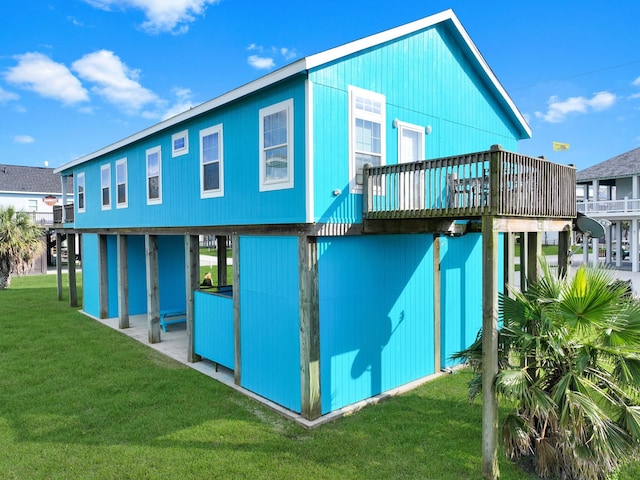 936 Surf Rd, Crystal Beach, TX 77650 - rear view of property with a lawn and a deck