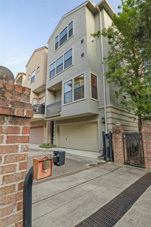 view of front of property with stucco siding, driveway, and an attached garage