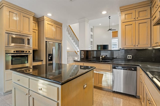 kitchen featuring appliances with stainless steel finishes, a sink, granite floors, recessed lighting, and ceiling fan