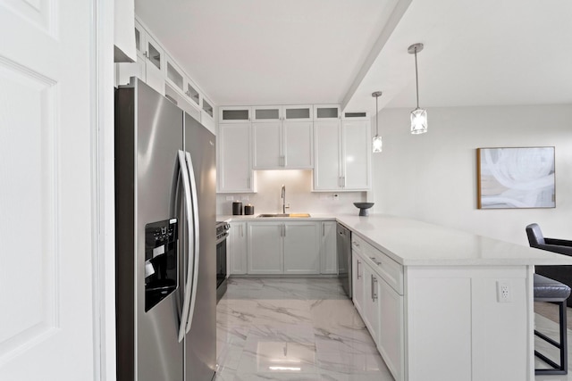 651 Bering Dr Unit 1406, Houston, TX 77057 - kitchen featuring appliances with stainless steel finishes, light marble finish flooring, a peninsula, a sink, and a kitchen breakfast bar
