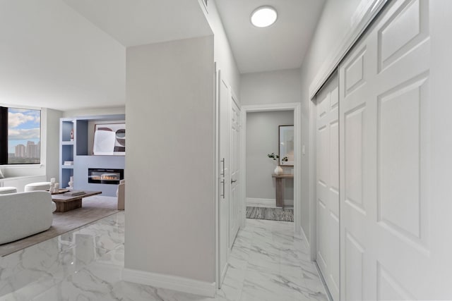 651 Bering Dr Unit 1406, Houston, TX 77057 - hallway featuring light marble finish flooring and baseboards