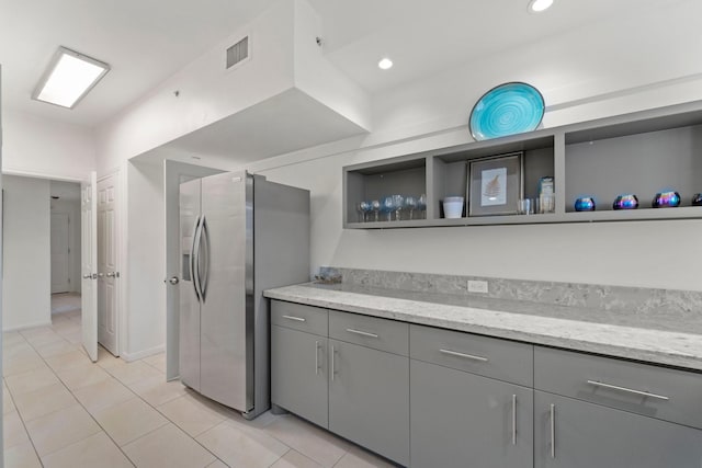 651 Bering Dr Unit 1406, Houston, TX 77057 - kitchen featuring stainless steel fridge, gray cabinets, open shelves, light tile patterned floors, and recessed lighting