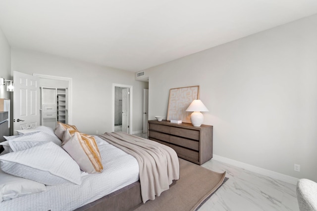 651 Bering Dr Unit 1406, Houston, TX 77057 - bedroom with light marble finish flooring, a spacious closet, a closet, and baseboards