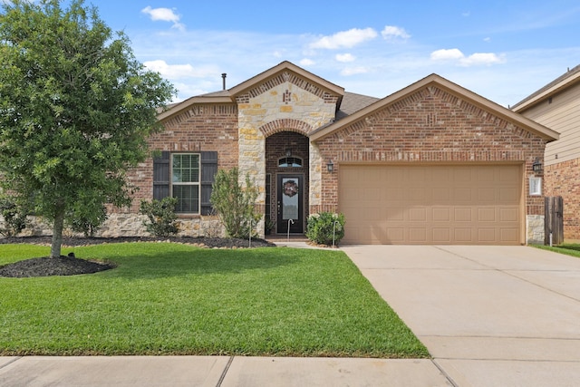 23522 Messina Harbor Dr, Katy, TX 77493 - french country inspired facade with stone siding, a front yard, an attached garage, brick siding, and concrete driveway