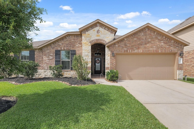 23522 Messina Harbor Dr, Katy, TX 77493 - french country home with stone siding, an attached garage, brick siding, a front yard, and driveway