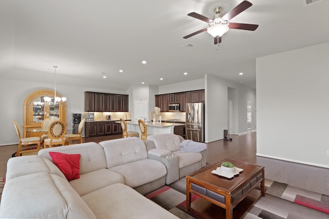 23522 Messina Harbor Dr, Katy, TX 77493 - living room featuring a chandelier, a ceiling fan, recessed lighting, baseboards, and dark wood-style flooring
