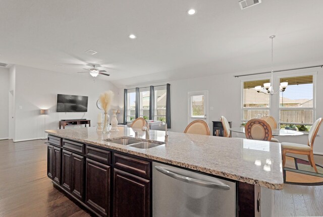 23522 Messina Harbor Dr, Katy, TX 77493 - kitchen featuring stainless steel dishwasher, a sink, a center island with sink, dark wood-style flooring, and open floor plan