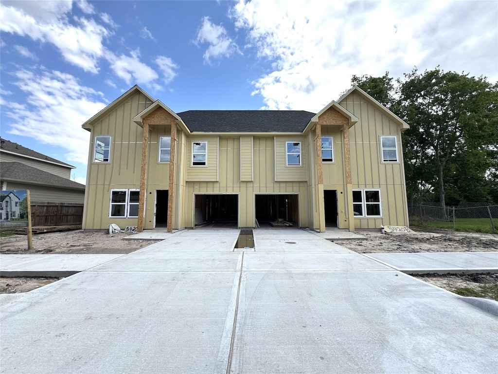 5420 Lynnfield St A/B, Unit A/B Houston, TX 77028 - view of front of house with board and batten siding, concrete driveway, and a garage